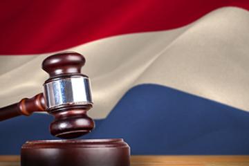 Hammer and gavel against 3d digitally generated dutch national flag