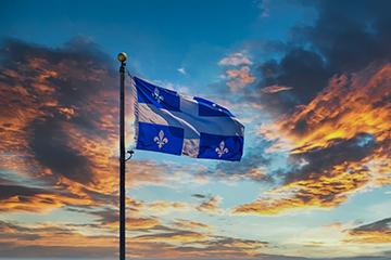 The Flag of Quebec flying against the sky
